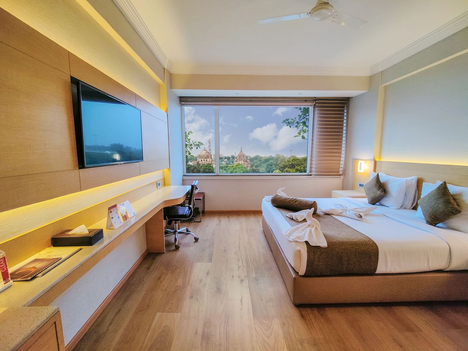 An overview of the Suite at Gemini Continental with a king bed and a tv opposite it.